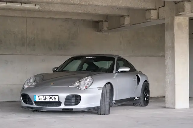 Trois quarts Avant de Porsche 996 Turbo grise sur un parking